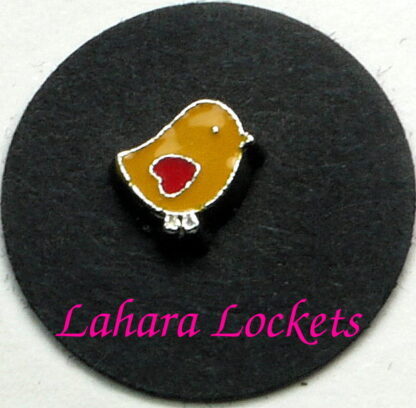 This floating charm is a yellow chick with red heart wing.