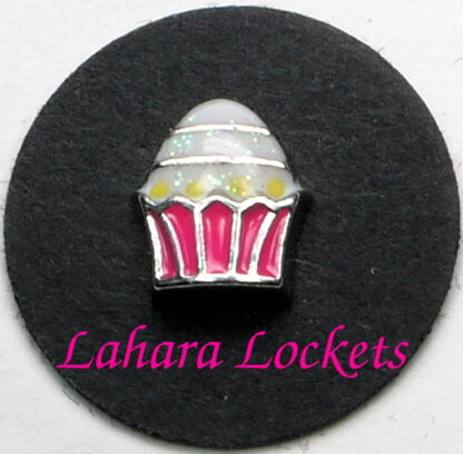 This floating charm is a cupcake with pink liner and shiny, white frosting.