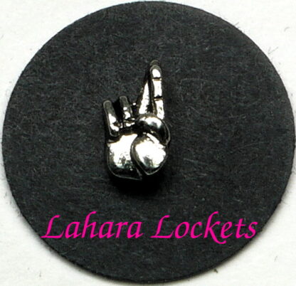 This floating charm is a silver hand with crossed fingers to signify good luck.