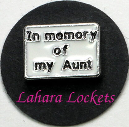 This floating charm is a white rectangle that says "in memory of my Aunt" in black letters.
