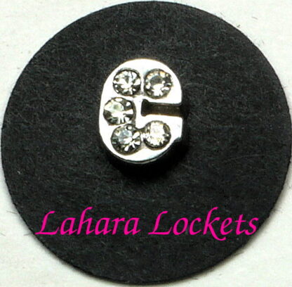 This floating charm is a silver letter c with clear gems.