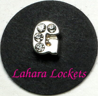 This floating charm is a silver letter G with clear gems.