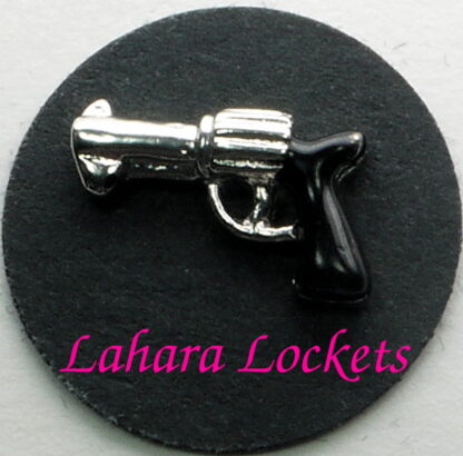 This floating charm is a silver revolver with a black handle.
