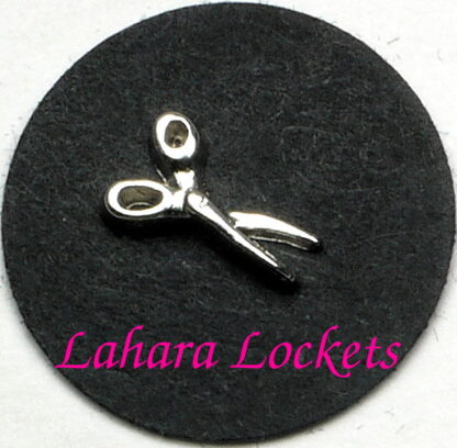This floating charm is a pair of silver scissors.