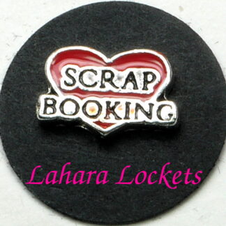 This floating charm is a red heart that says scrap booking in black and silver.