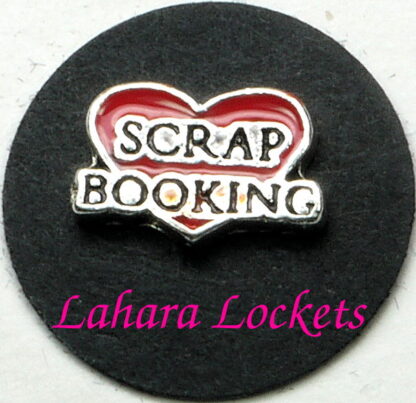 This floating charm is a red heart that says scrap booking in black and silver.