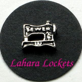 This floating charm is a black and silver, retro sewing machine that says sewer on it in silver.