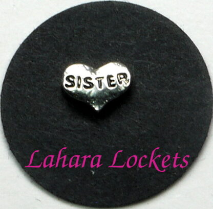 This floating charm is a silver heart that says sister in black letters.