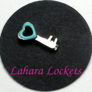This floating charm is a silver key with teal, heart shaped head.