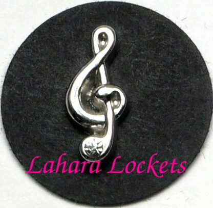 This floating charm is a silver, treble clef with a gem accent at the bottom.