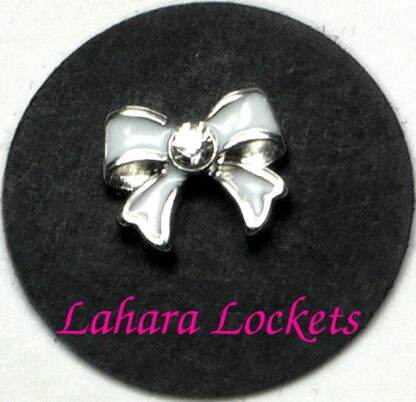 This floating charm is a white bow with a clear gem in the center.