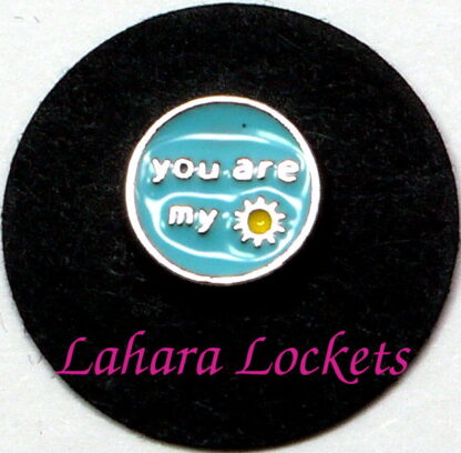This circular floating charm says "you are my sunshine" in siver letters and has a yellow sun on a light blue background.