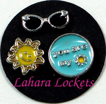 This is a trio of floating charms that would look together in a memory locket; you are my sunshine, sun and sunglasses.
